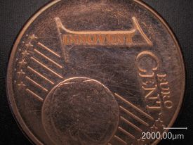 For demonstration of the spatial resolution: Laser engraving the lettering "INNOVENT" on a 1 €-cent coin is shown.