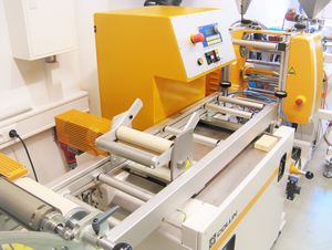 The picture shows the flat film line with 3-roll chill-roll and the clamping and winding device.